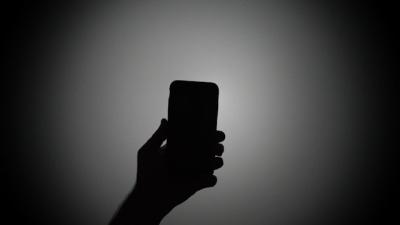 Silhouette of a person holding a smartphone image linking to Security at what cost? Mobile data shutdown pushes Pakistan’s Balochistan further into isolation