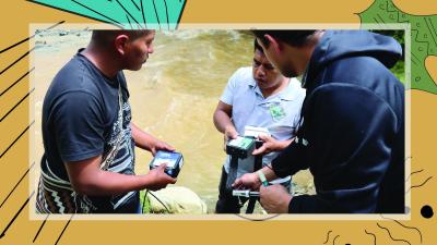 "Three men use monitoring devices beside a river during fieldwork." image linking to Seeding change: Community networks cultivating a future where technology and social and environmental care grow together